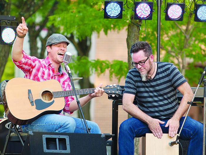 Singer Michael Joseph Green, left, and Marc Dalzell perform a set of songs for crowds outside of the Downtown Chatham Centre July 26 as part of a summer concert series. Sharing his Christian belief through song, Green also writes a portion of his material. 