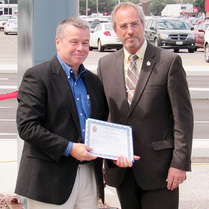 Dean Bradley, left, president of Brad-Lea Meadows, accepts congratulations from Chatham-Kent Mayor Randy Hope at the Thames Lea Plaza’s grand re-opening Friday.