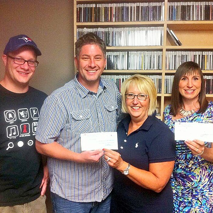 Dave Richie photo Jordon Matteis, left, and Chris McLeod hand over proceeds from the sixth annual Nik McLeod Moustache Memorial Golf Tournament to Michelle Grzebien-Huckson and Rachel MacLeod. Grzebien-Huckson accepted $1,000 on behalf of the Foundation of the Chatham-Kent Health Alliance, while MacLeod received $4,000 for the Chatham-Kent Branch of the Canadian Cancer Society.