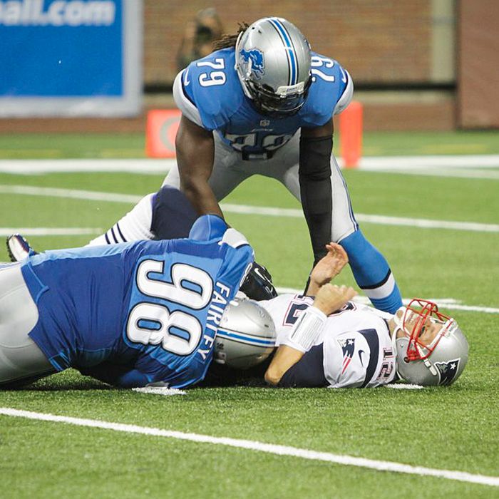 Patriots quarterback Tom Brady winces in pain after a big hit from Lion DT Nick Fairley in Aug. 22 preseason action.
