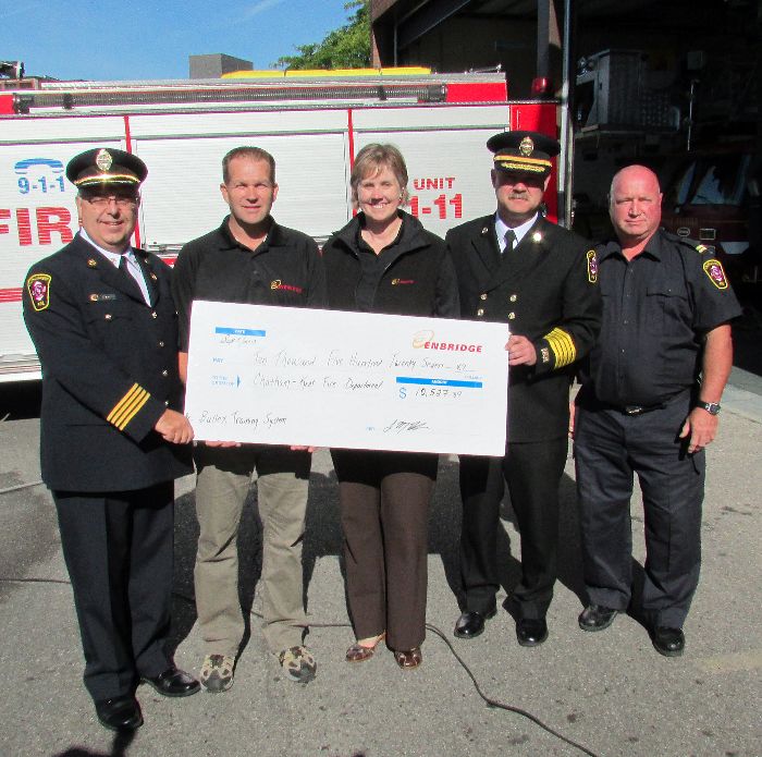 From left, Chatham-Kent Assistant Fire Chief Rick Arnel, Enbridge’s Glenn Anderson and Cynthia Lockrey, C-K Fire Chief Ken Stuebing and C-K Fire Capt. Mark Zimmer showcase Enbridge’s donation of more than $10,500 that funded a Bull Ex fire control training system.