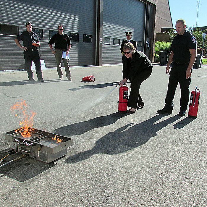Enbridge Inc.’s Cynthia Lockrey tries her hand at the proper use of a fire extinguisher with the new Bull Ex training system her company purchased for the Chatham-Kent Fire Department. The Bull Ex unit will be housed at the Thamesville station and will be used to train the public on the proper way to fight a fire with an extinguisher.