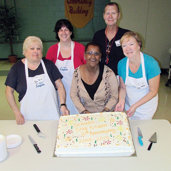 St. Agnes community soup kitchen committee members celebrate 10 years with cake and ice cream for their guests. Pictured from left is Barb DeWaal, Nancy Bourassa, Ethel Simmons, John Rush and Lyn Rush. Missing from the photo is Patricia Ribberdy.