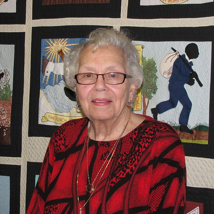 Gwen Robinson stands in front of a quilt displayed at the Black Mecca Museum. Robinson, a tireless researcher of black history, is one of the founders of the museum at the WISH Centre in Chatham.