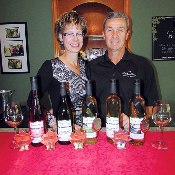 Sue and Mike Korpan of Early Acres Estate Winery near Chatham have reason to be happy, posing with their award-winning line-up of wines.