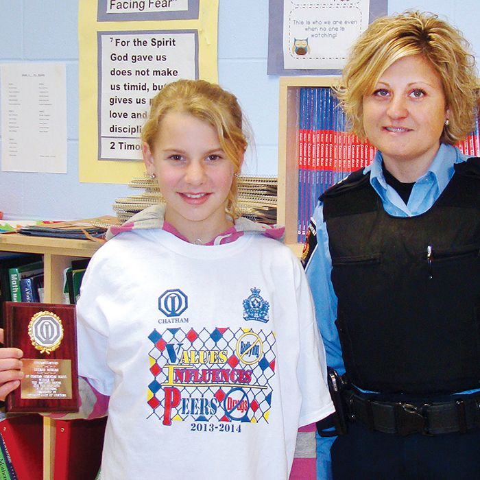 Leann Morgan, left, shows off the plaque she earned for winning the 2013-14 VIP design contest. With her is Spec. Const. Randi Hull of the crime prevention and community safety section of the Chatham-Kent Police Service