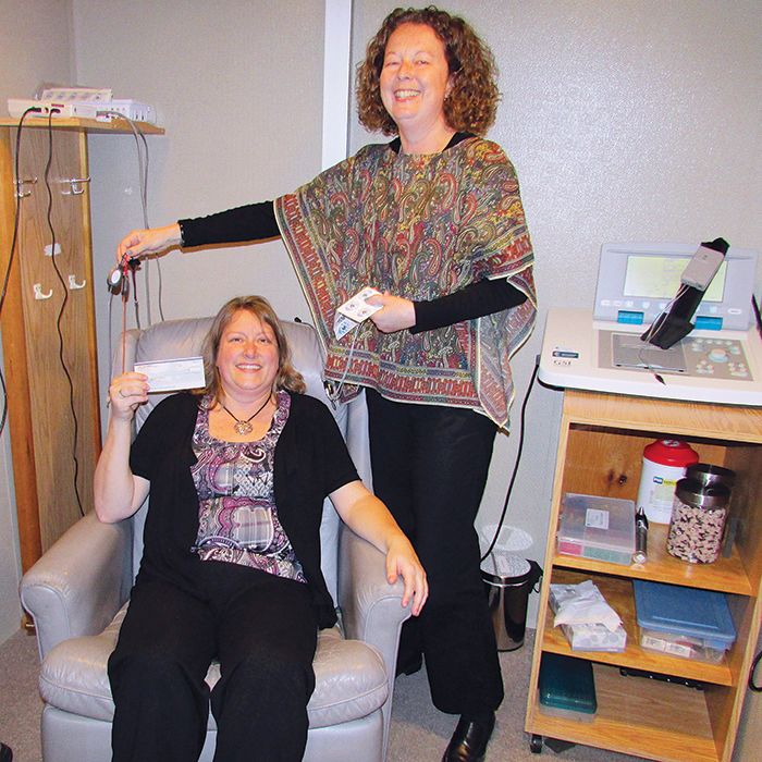Audiologist Sandra DeKok, right, with the Children’s Treatment Centre of Chatham-Kent, showcases new auditory brainstem response testing equipment to Tammy Craeymeersch, president of  the Sertoma Foundation of Canada.