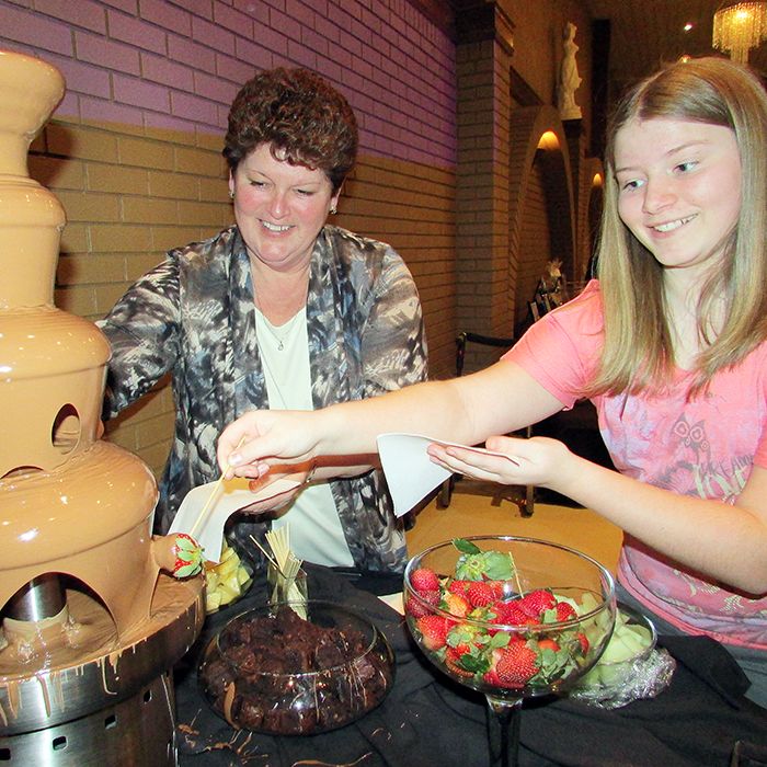VON Chatham-Kent’s Jan Reinhardus and the author’s daughter, Brenna Corcoran, can’t wait to enjoy a chocolate-covered strawberry at the Chocolate Lovers Brunch March 2.