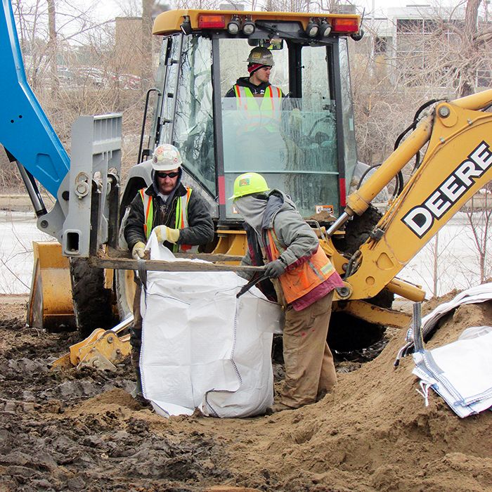 A crew works to fill sandbags on the river side of the Union Gas property on Keil Drive in Chatham Wednesday.