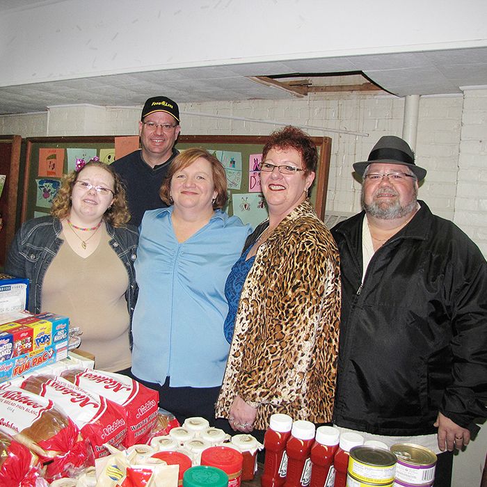Tammy and Brent Ripley, far right, were on hand to give eight local soup kitchens food donations for their programs. The Ripleys, who organize the annual Community Cares Christmas dinner, invited representatives of the soup kitchens to pick up their food boxes Saturday at St. Andrew's United Church. The Ripleys have been overwhelmed by the generosity of people and businesses that stepped in with donations after the family’s home was broken into just days before last year’s dinner. Also pictured are Sam Ripley; Scott O'Brien, general manager of Food For Less; and Anne Gibson, soup kitchen co-ordinator for the St. Andrew's and Victoria Avenue United Churches.