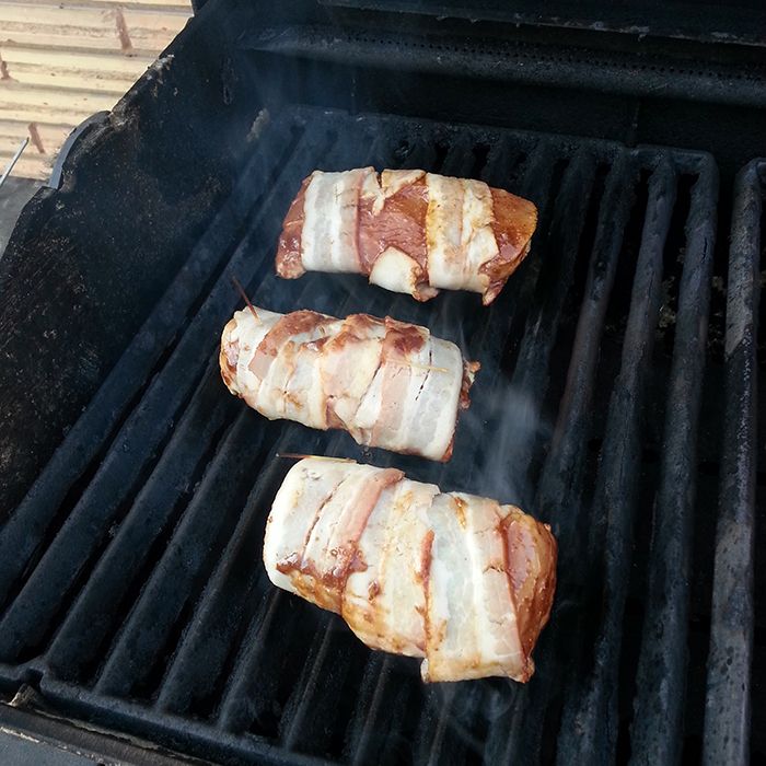 Bacon-wrapped pork tenderloin on Bruce's tired, but still very functional barbecue.