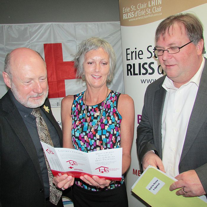 From left, Brad Davis, executive director of Family Services Kent; Cheryl Tompkins, senior manager with the Canadian Red Cross; and Ralph Ganter, senior director with the Erie-St. Clair LHIN, go over a Homeward Bound brochure. The program, recently put in place in Chatham-Kent, helps senior citizens transition from a hospital stay back into their homes.