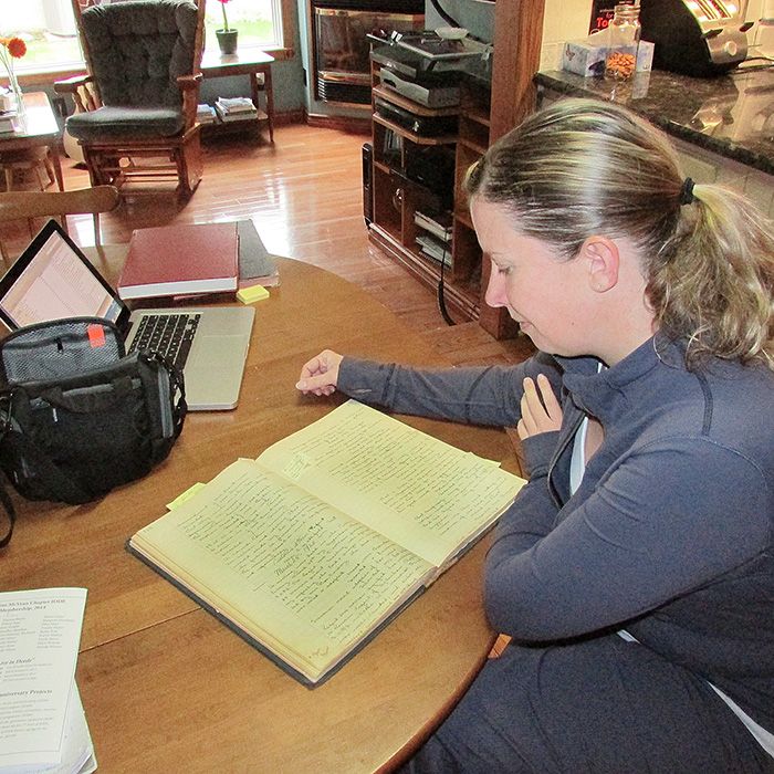 Fifth-generation Dresden IODE member Jana Grubb examines the original minute book from the group, which was formed in 1914.