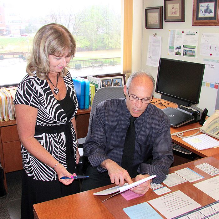 Chatham-Kent Director of Planning Services Ralph Pugliese is retiring this month after a 31-year career as a planner in Chatham-Kent. Here he checks out a report with administrative assistant Janice Lally.