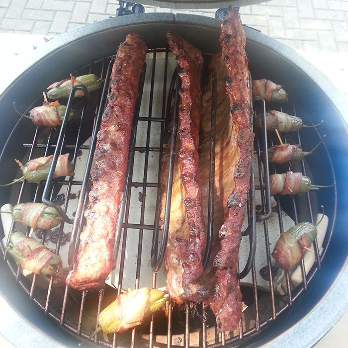 Baby back ribs sit surrounded by ABTs on Bruce's barbecue. There should have been a mushroom cloud above those stuffed peppers!