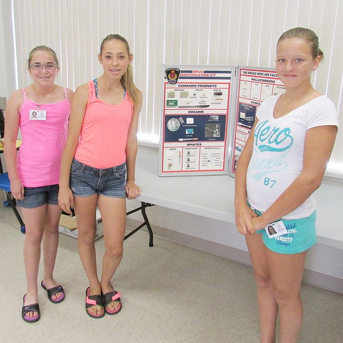 From left, Cop Camp participants Madison Vickery, Megan Hakr, and Kamryn Hull examine a drug identification kit during their week of camp at the Chatham-Kent Children’s Safety Village.