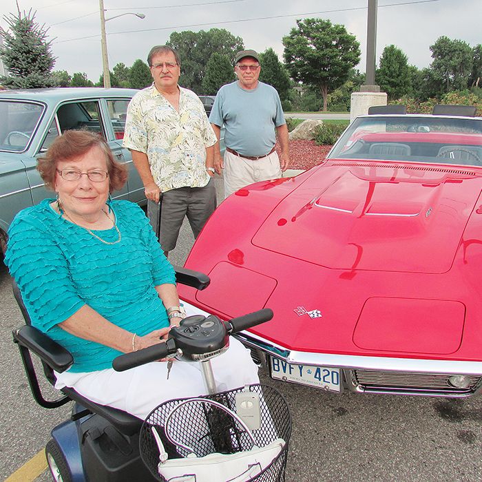 A&W owner Bob Moon, in back, shows off his 1968 Corvette that he has restored and showcased during the Cruisin’ for a Cure fundraising event Thursday evening. With him are Ron Smolders, standing, and Anne Mann, who live daily with the symptoms of Multiple Sclerosis.
