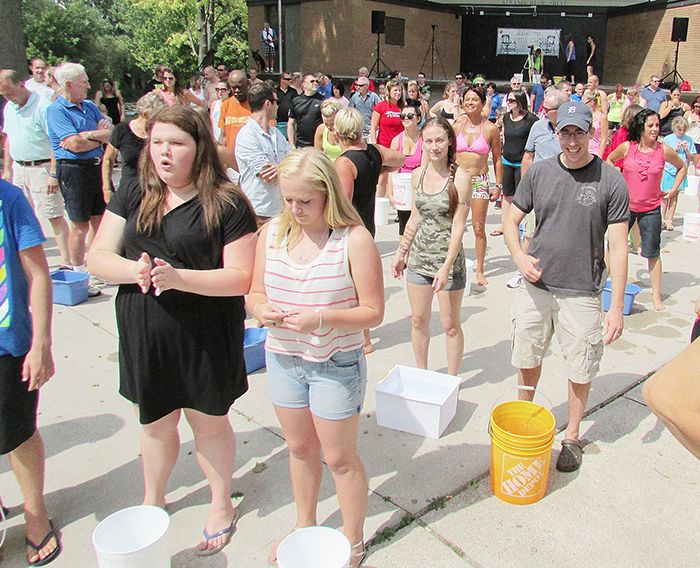 Chatham and area residents prepare to perform the ALS Ice Bucket Challenge Sunday in Tecumseh Park.