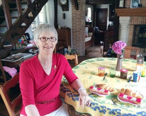 Diane Teetzel sits down to enjoy a croissant and an eclair decorated with icing that resembles a Canadian flag served up as part of the 70th anniversary celebrations of the liberation of Criquebeuf-sur-Seine.
