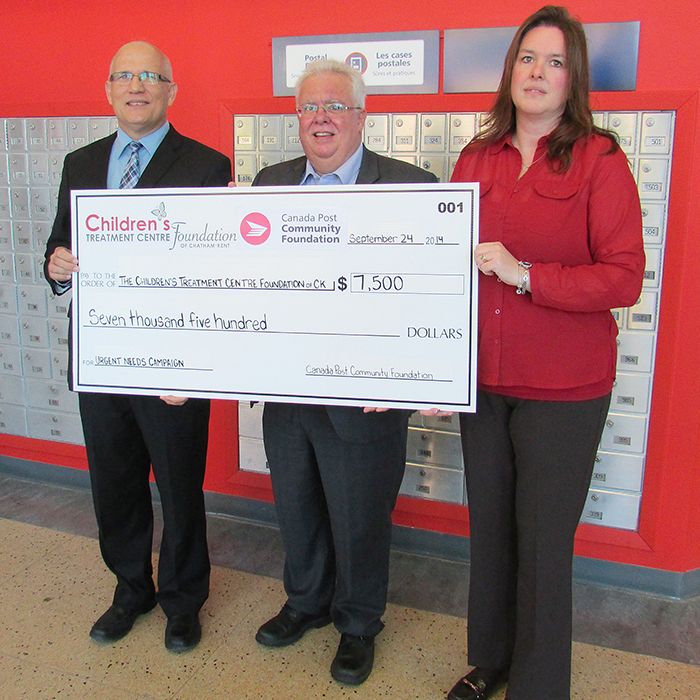 Canada Post regional manager Tad Wolanski, left, and local area superintendent Wendy Vercauteren, right, hand over a cheque for $7,500 to Art Stirling, executive director of the Children’s Treatment Centre Foundation of Chatham-Kent. The funds are earmarked for phase 2 of the urgent needs campaign that’s part of the centre’s Kids Can’t Wait program.