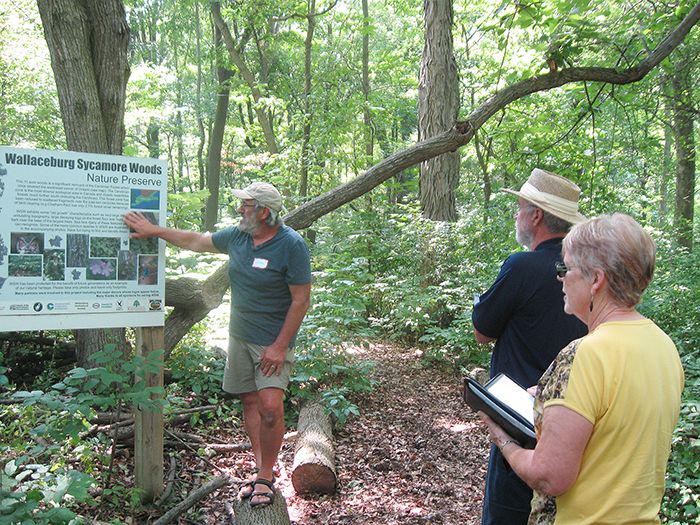 Sydenham Field Naturalist Larry Cornelis, left, shared the success story of the preservation of Wallaceburg's Sycamore Woods Nature Preserve with international judges Jim Baird and Berta Briggs while they visited Chatham-Kent in July. The judges were so impressed by activities such as this throughout Chatham-Kent that we received special recognition for our preservation of natural sites by volunteers.