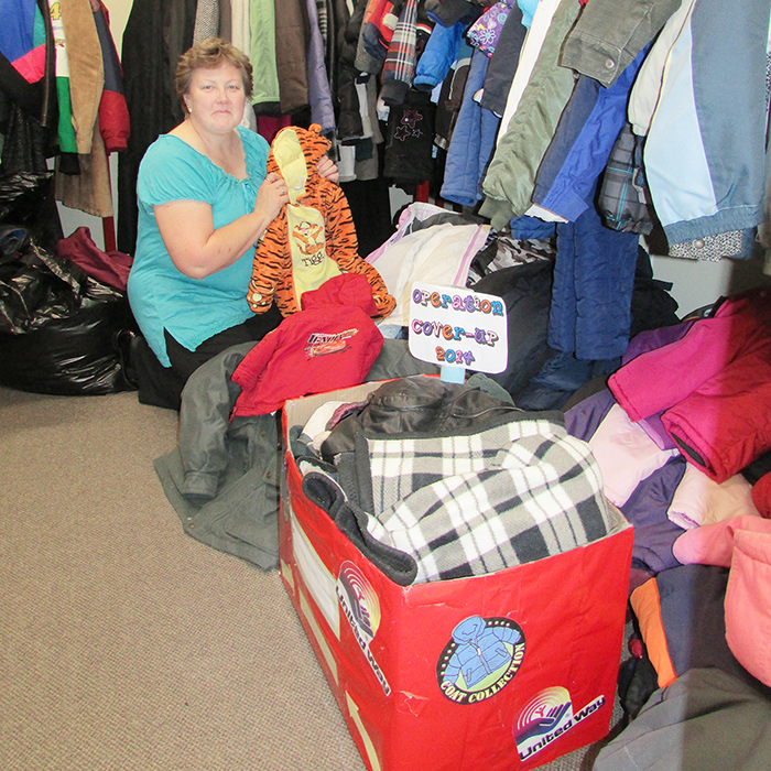 Mary Symons, Good Neighbours co-ordinator with the United Way, sorts through some of the coats received during Operation Cover Up this year. Coats are being handed out by voucher until Nov. 15.