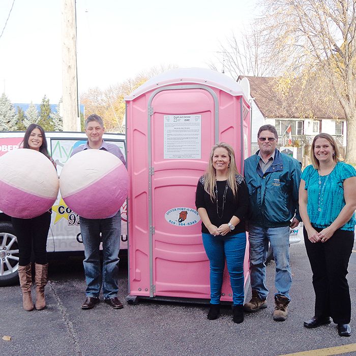 From left, Sam East and Chris McLeod, the Two Boobs in a Bucket; Kelly and Romain Caron of Dover Port-a-John, suppliers of the pink port-a-potty for the Flush Out Cancer campaign, and Krissy Rioux, fundraising assistant for the Chatham-Kent branch of the Canadian Cancer Society.