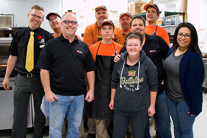 Little Caesars Employees and Jobmatch representatives take a break from making and packing pizzas.