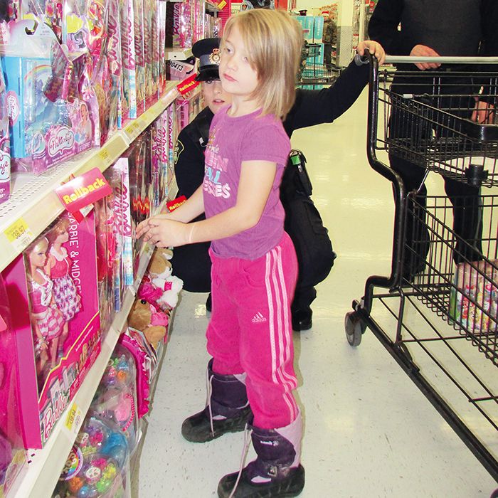 Rachel McLean, 6, had some tough decisions to make in the toy aisles of Wal-Mart Saturday morning. Her Shop with a Cop assistants, OPP Aux. Const. Rich Fleming and Const. Katie O’Neill, offered advice where they could.