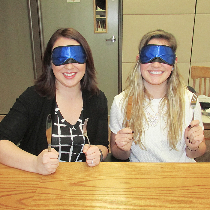 Sarah Regnier, left, a board member of the Children’s Treatment Centre of Chatham-Kent; and Shelby Sanchuk, communications and fundraising assistant with the centre’s Foundation, get in a little practice for their approaching Dining in the Dark fundraiser Jan. 22. Guests will dine blindfolded and will have the opportunity to experience other sensory deprivation over the course of the evening.