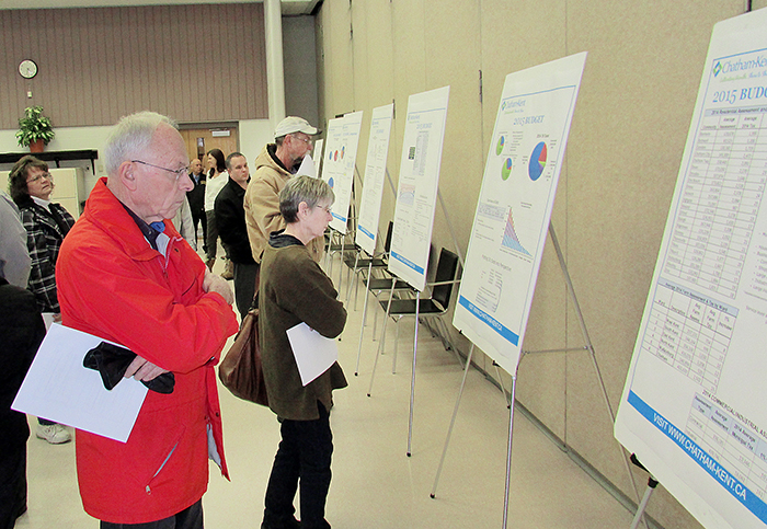 Michael Murphy and other citizens examine information municipal staff put out at Thursday's public input session on the budget, held at the Active Lifestyle Centre in Chatham.