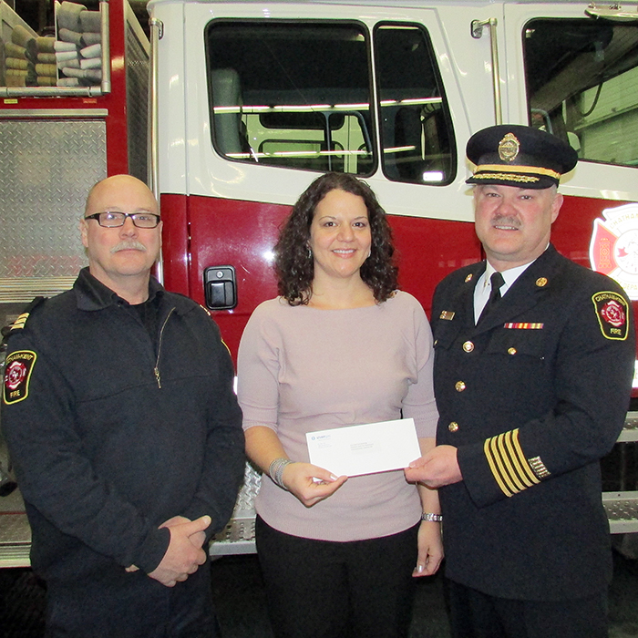Diane Pisani, construction and growth manager for Union Gas for Windsor and Chatham, presents Rick Lapp, left, senior captain with the Chatham-Kent Fire and Emergency Services, and chief Ken Stuebing with a cheque for $5,000 to help fund the ckfire.com website redesign.