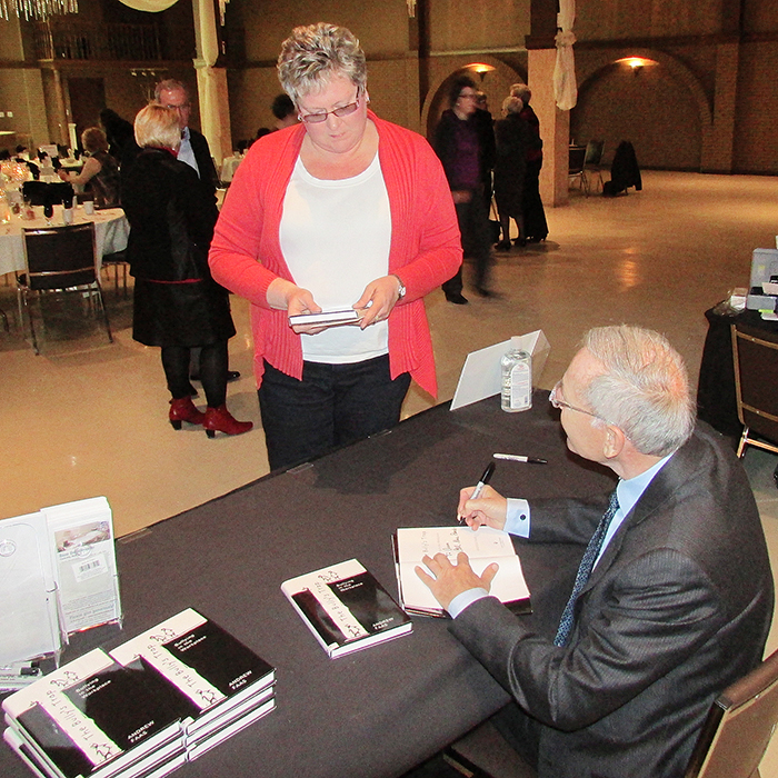 Ann Pollack receives her signed copy of Andrew Faas’ book, “The Bully’s Trap,” during a luncheon sponsored by the Foundation of the Chatham-Kent Health Alliance.