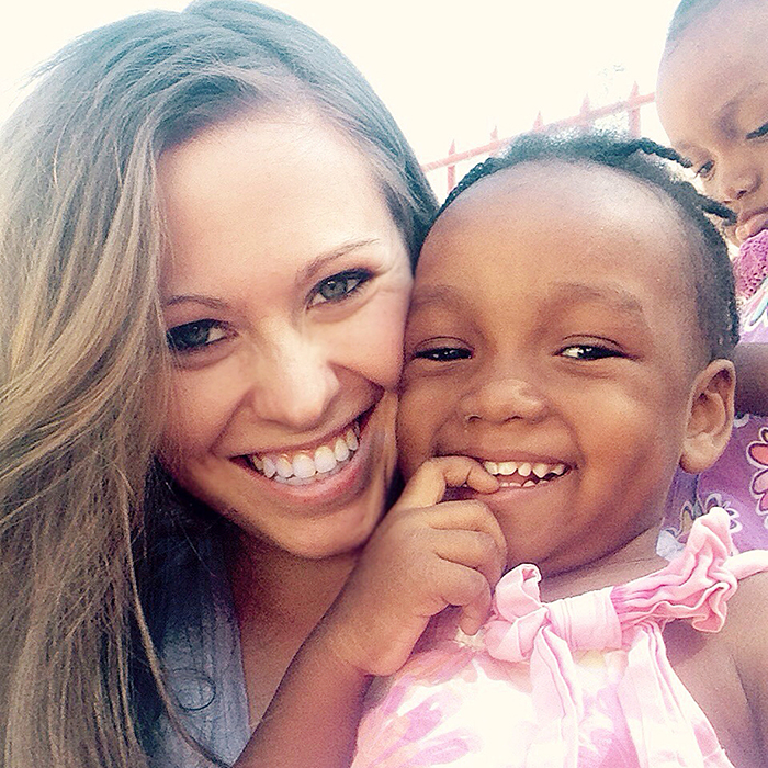 Emily Hime and one of the 20 children who live at her orphanage in Haiti. 