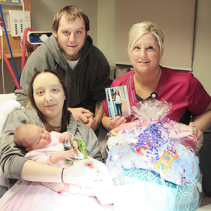 Baby Rylie Osborne with her parents Rachel Rhea and Brad Osborne, and Jolene Hathaway, RPN, who delivered a gift basket in honour of the late Sophia Vlasman to the young family.