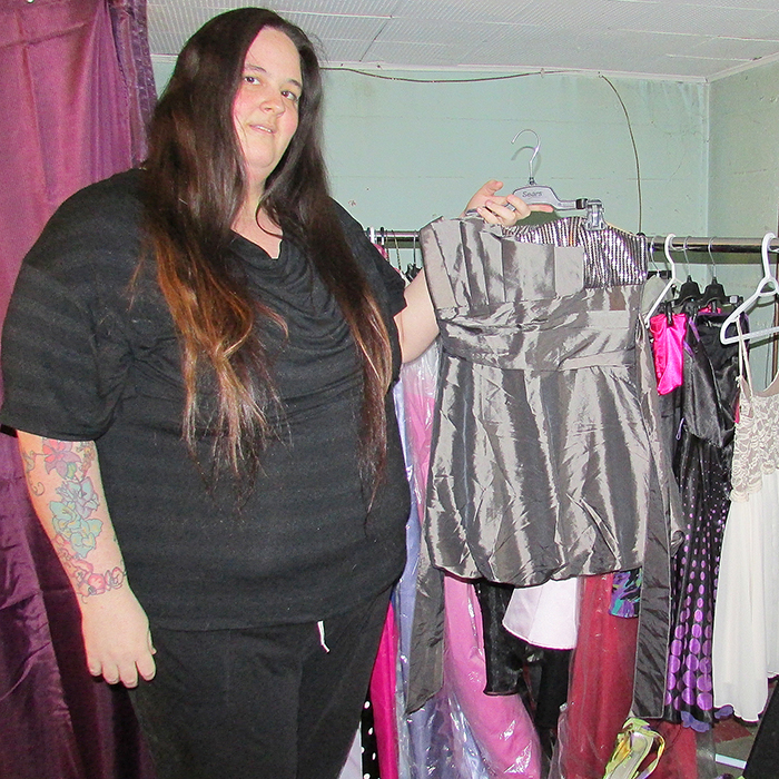 Jenna Postma, organizer of The Cinderella Project, shows one of the 20 dresses donated to help young girls look and feel their best on grad or prom night.