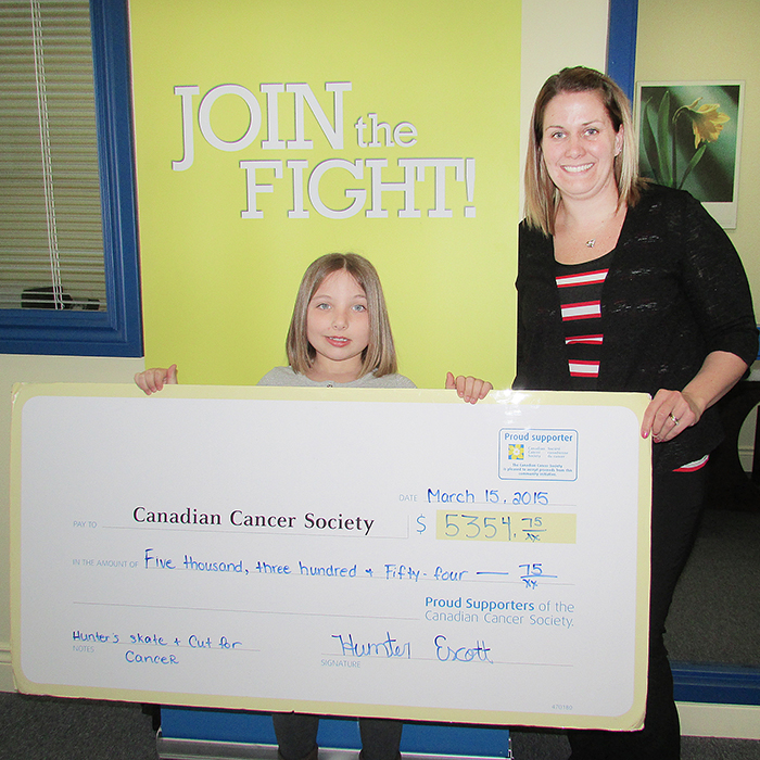 Hunter Escott, 8, donates the proceeds of a fundraiser she led March 15 to Krissy Rioux of the Chatham branch of the Canadian Cancer Society.