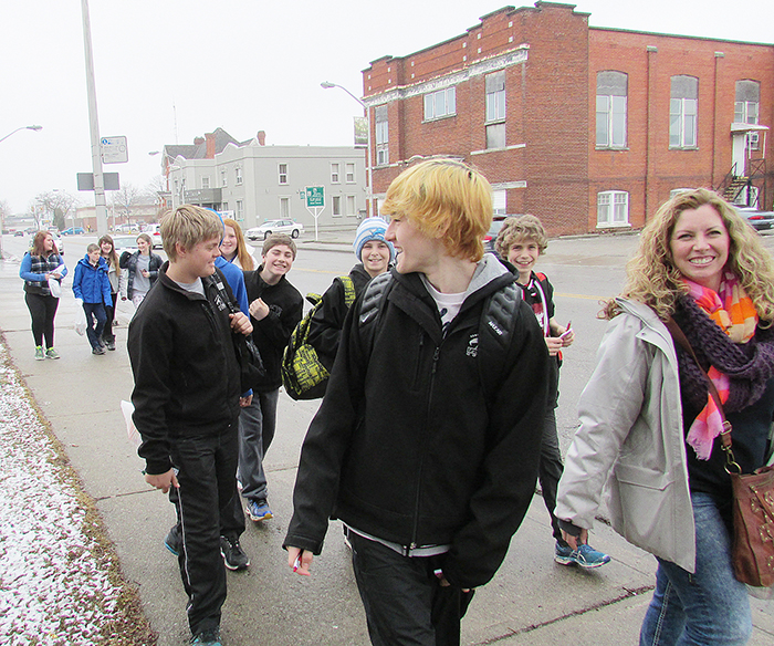 Participants in the El Camino Walk March 26 in Chatham walk down Wellington Street towards one of the local charities where they made donations. About 70 Grade 8 students from three local schools learned of the actual Camino Walk in Spain where people conduct an 800-kilometre pilgrimage to reflect on their lives.
