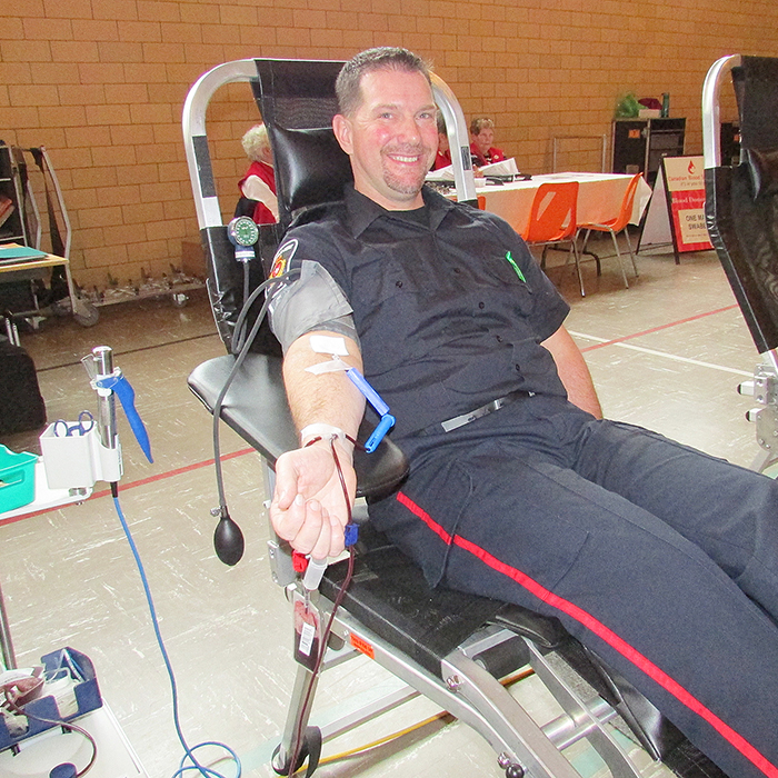 Const. Doug Cowell donates at the Canadian Blood Services clinic April 8 at the Spirit and Life Centre in Chatham. It was Cowell’s 34th time giving blood.