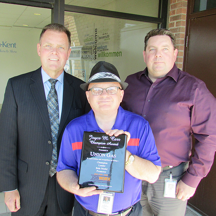 Union Gas’ Paul Rietdyk, vice president; Kevin Williamson and Lavern Hanley showcase the Joyce M. Carr Champion Award the company earned at Friday’s launch of Community Living Month. For the past 25 years, Williamson, a Community Living member, has worked at Union Gas.