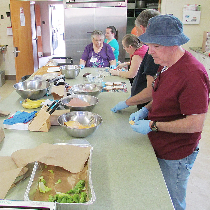 Volunteers at Vinnie’s Friday Lunch soup kitchen at the Spirit and Life Centre on Wellington Street in Chatham prepare lunches for those in need. Changes to the weekly charity effort have freshened things up a bit. 