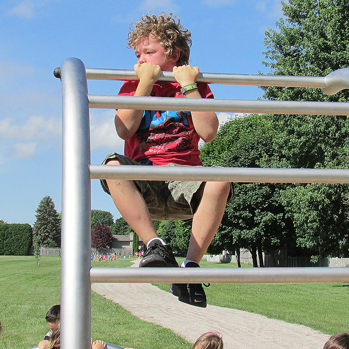 Youngsters wasted no time jumping on the newly dedicated fitness stations at the Tecumseh Public School Fit Trail on Tuesday. The one-kilometre trail was three years in the making. Here, Ryelly Hill, a Grade Three student, shows his muscles by doing a pull up.