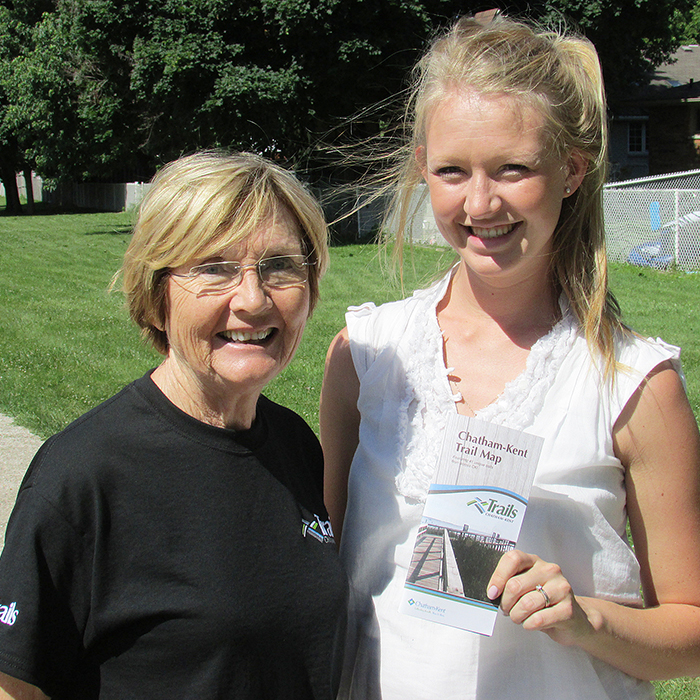 Dianne Flook of the Chatham Kent Trails Committee and Kathryn Kielstra of the Chatham-Kent municipal parks department show off a copy of the latest guide to trails in the community. The booklet lists location, maps and a description of each of more than 40 local trails.