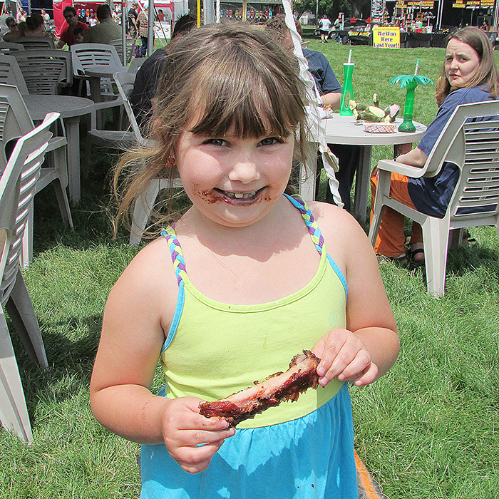 Haley Sowinski, 6, of Chatham, loves her ribs and loves RibFest every year.