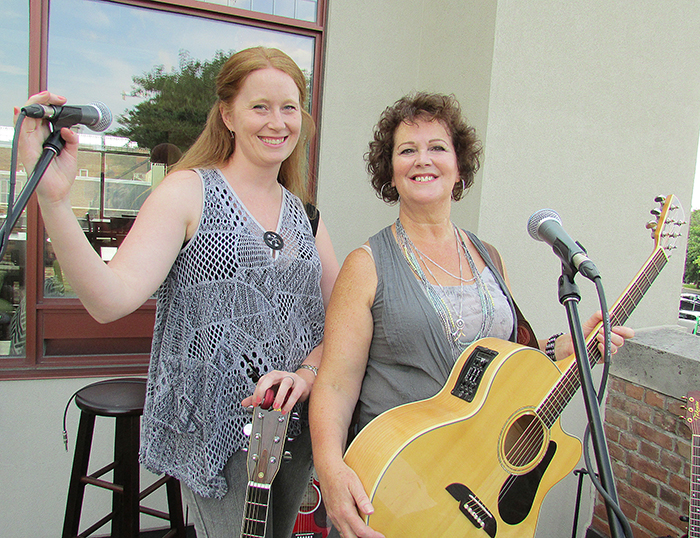 Leia Weaver, left, and Julie Ross performed recently at the intimate and outdoors venue of the second-floor patio at the St. Clair College Capitol Theatre. Ross runs weekly Song C!rcle events on the patios Friday evenings, and they are gaining popularity.