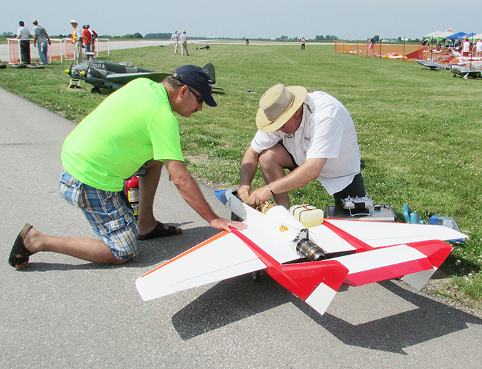 Peter Doupnik, right, of Windsor, powers up his turbine trainer jet as Murray Verarity assists. Doupnik’s jet roared over the Chatham Airport Saturday, entertaining spectators with its aerobatic ability.