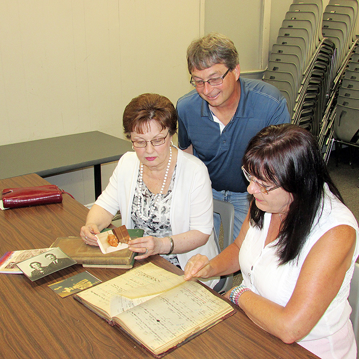The Czech Hall in Dresden is home to a Czechoslovakian library of more than 1,000 titles thanks to the generosity of a local family. Nancy Gagnon, left, and her sister Joanne Bartosek donated the library of their grandfather Frank Lacina who immigrated to Canada in the 1920s. Here, the women examine Frank’s ledgers that showed information about which books were lent. Looking over the information is Czech Hall president Al Kominek.