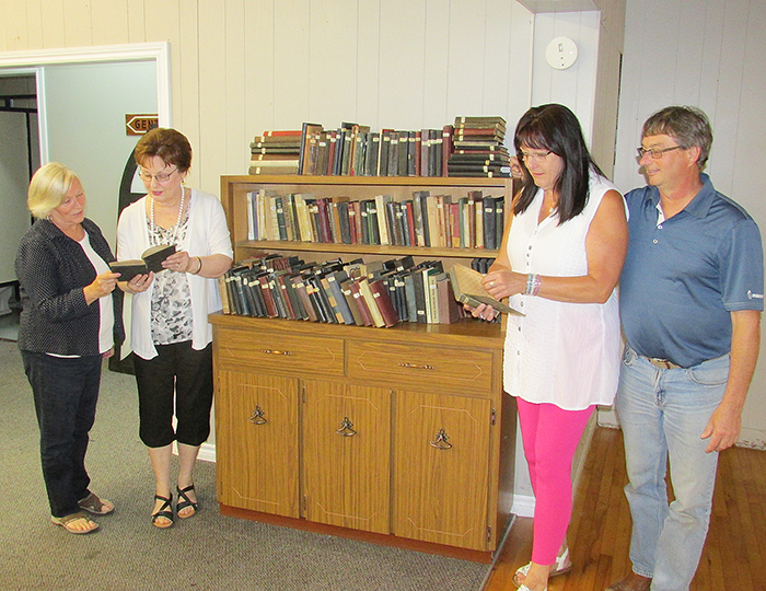 This bookshelf holds some of the Czech books donated by the family of Frank Lacina, who collected more than 1,000 volumes in his native language and loaned them to newcomers to Canada. Here, Marian Kominek, Nancy Gagnon and Joanne Bartosek (Lacina’s granddaughters) and Al Kominek, president of the Czech Hall in Dresden, look at the books that will be housed at the hall.