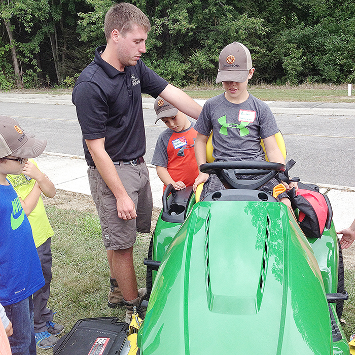 McGrail Farm Equipment staff explained the hazards riding lawn mowers to the young participants in the Farm Safety Day held at the Chatham-Kent Children’s Safety Village Aug. 26.