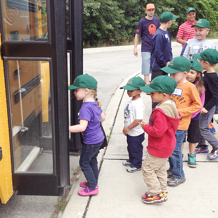 Young participants in the Farm Safety Day held at the Chatham-Kent Children’s Safety Village practice boarding a school bus.